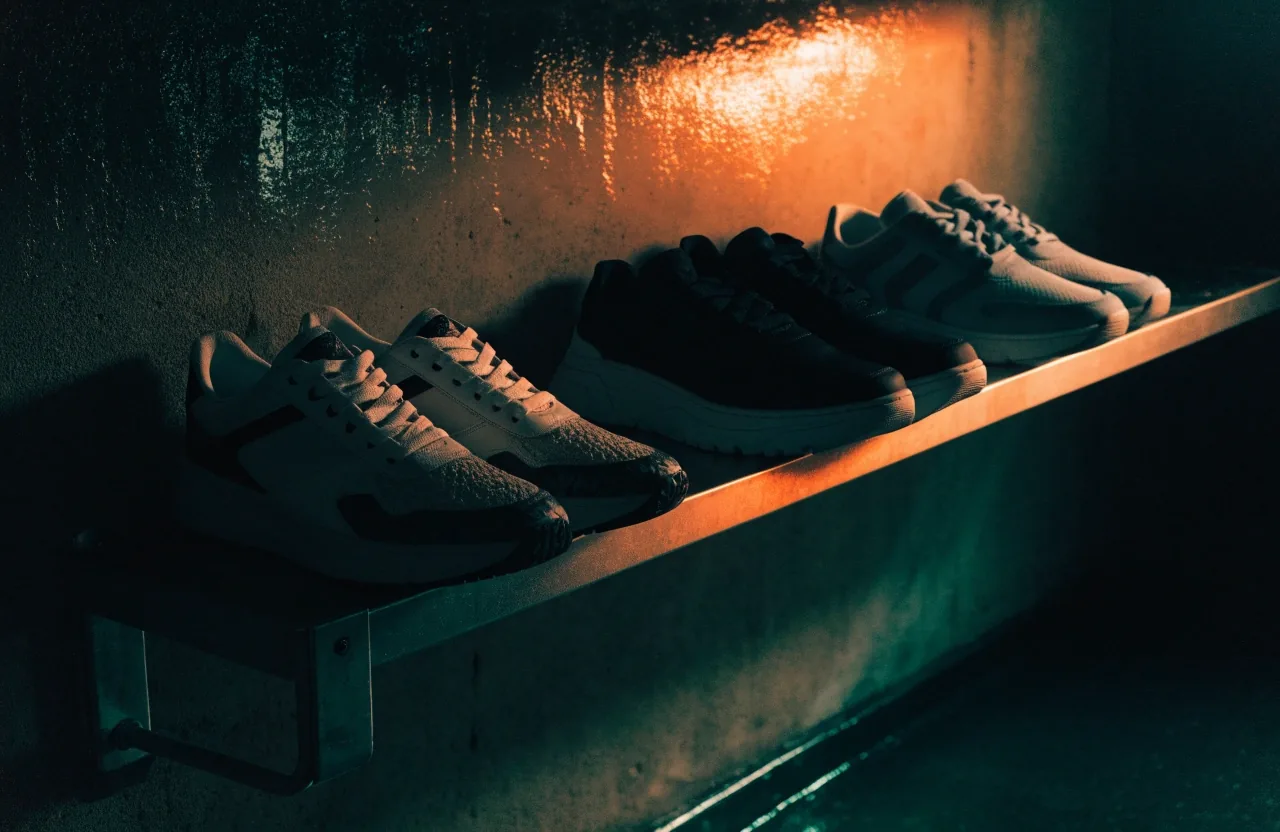 Sneakers urbaines basses sans marque posées sur une étagère murale